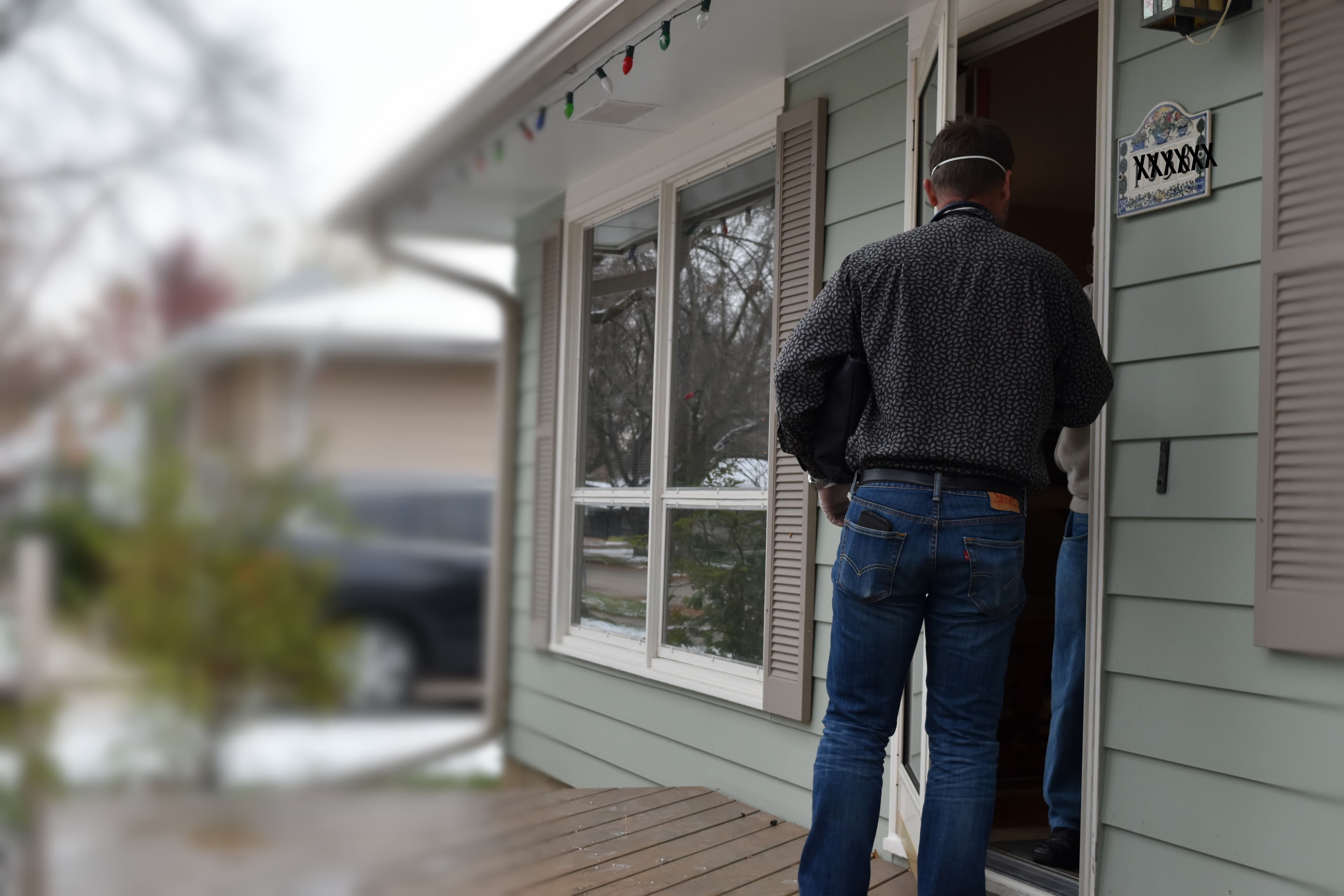 A Comfort Health team member arriving at a Rochester client's front door for a scheduled visit.