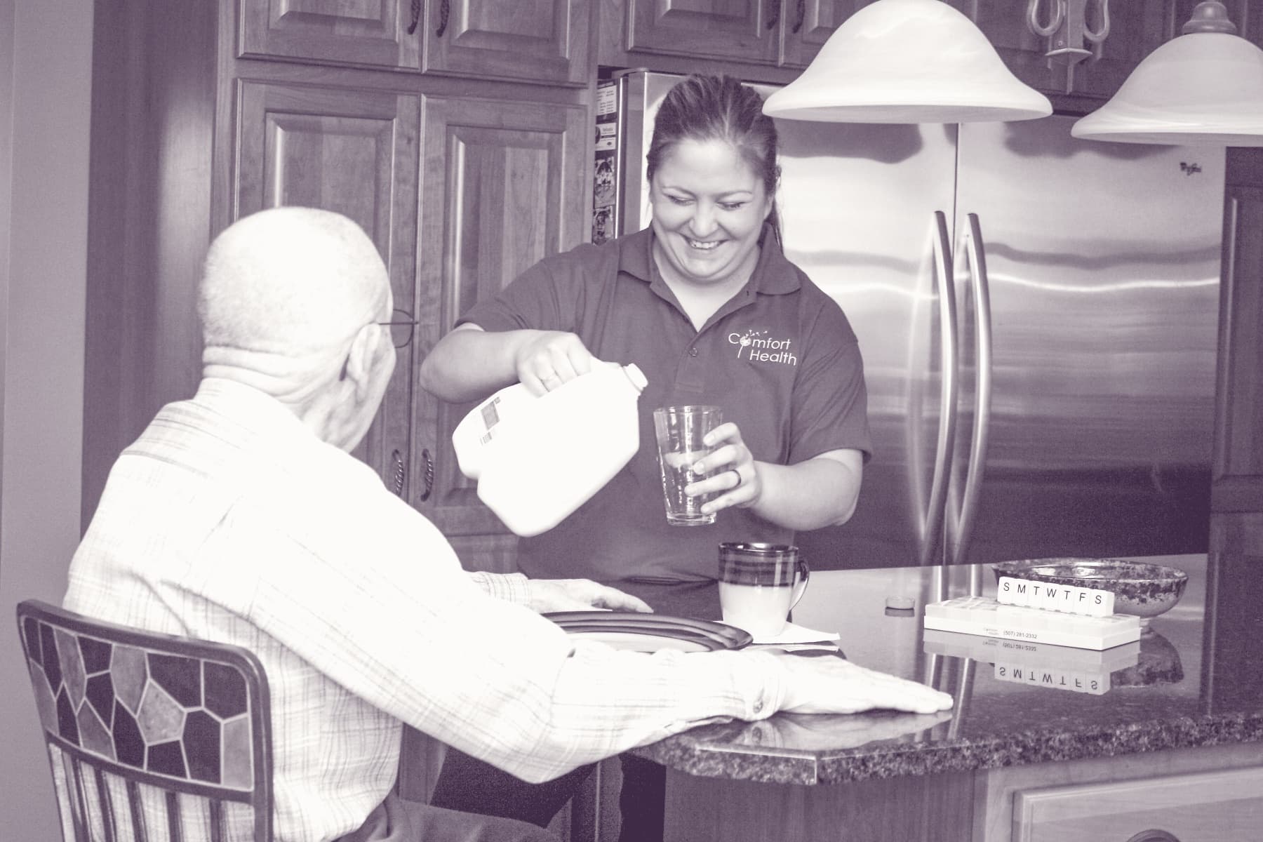 A Comfort Health caregiver preparing a meal in a Rochester client's kitchen.