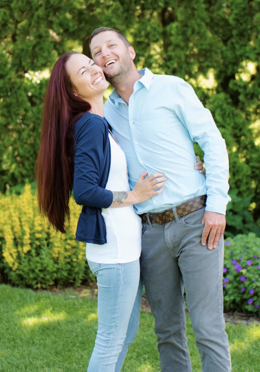 Alex and Kelsey Knapp, owners of Minneapolis Decks, photographed together in a Twin Cities garden