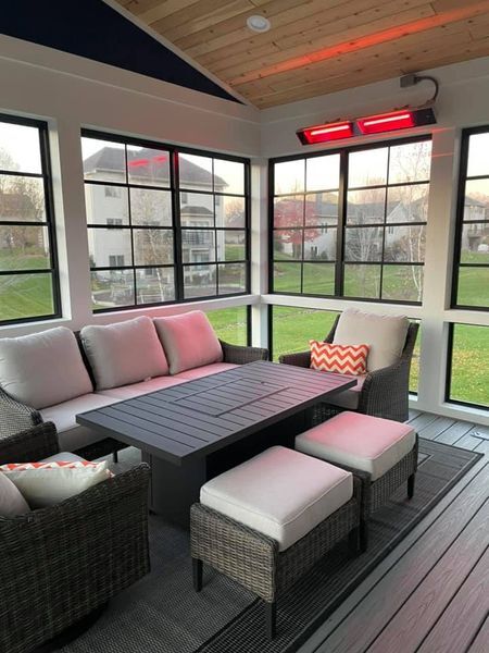 Excelsior screened porch — Modern screened build with infrared heat, dark window frames, and a wood-clad ceiling. The room you can sit in in November.