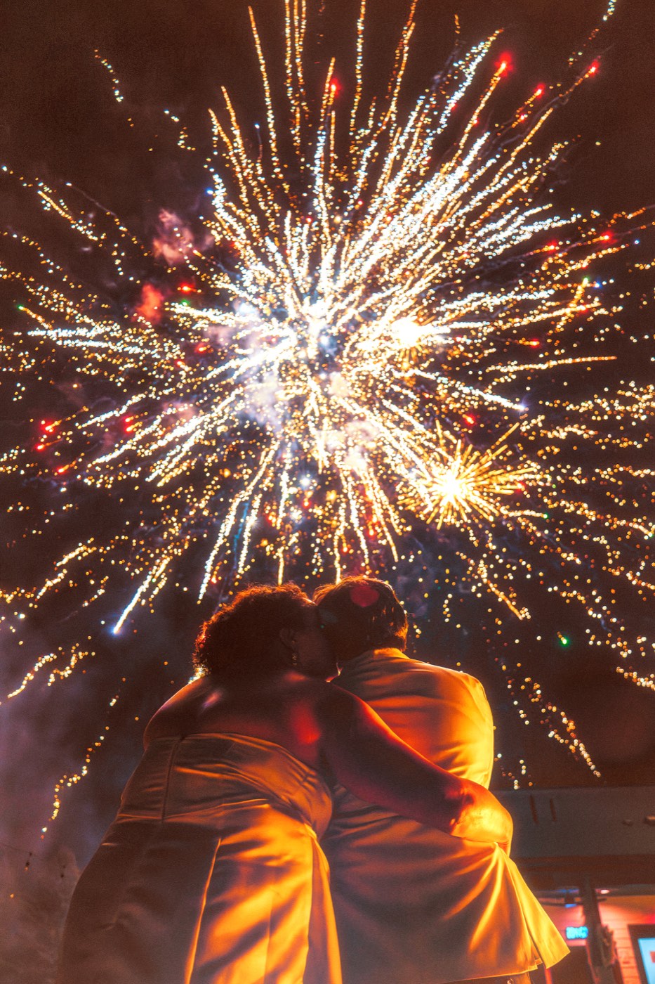 Couple lit by sparklers at dusk