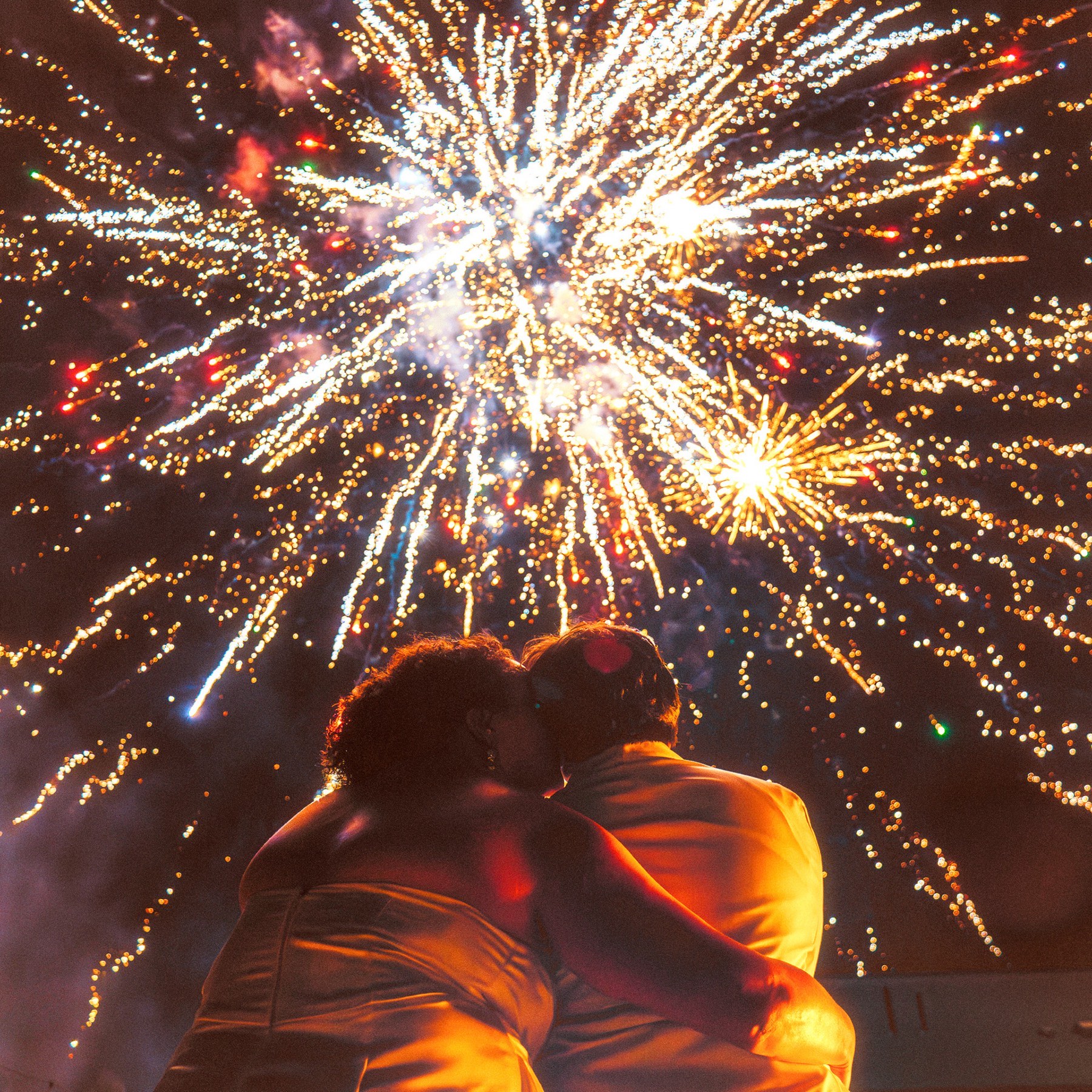 Sparklers held up at a festival at dusk