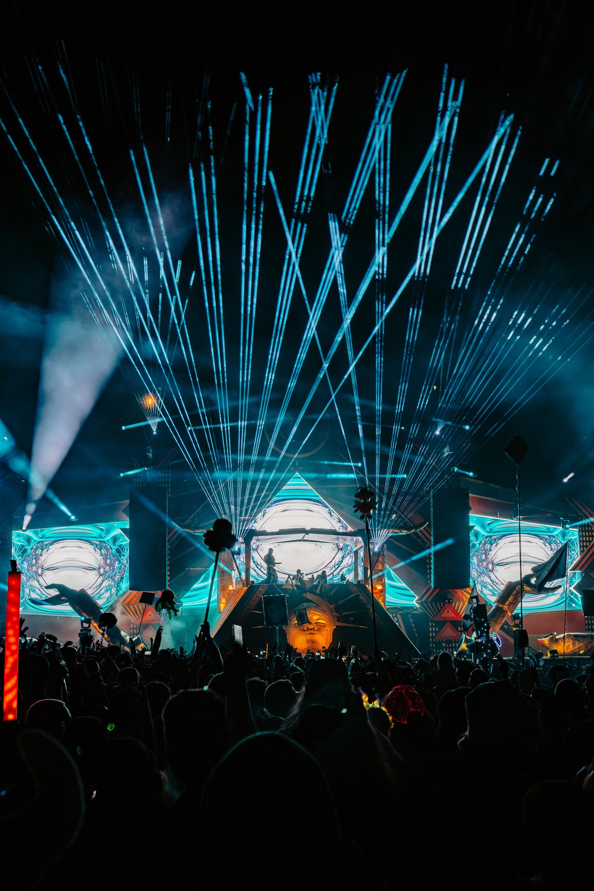 Stage beams sweeping over a live crowd