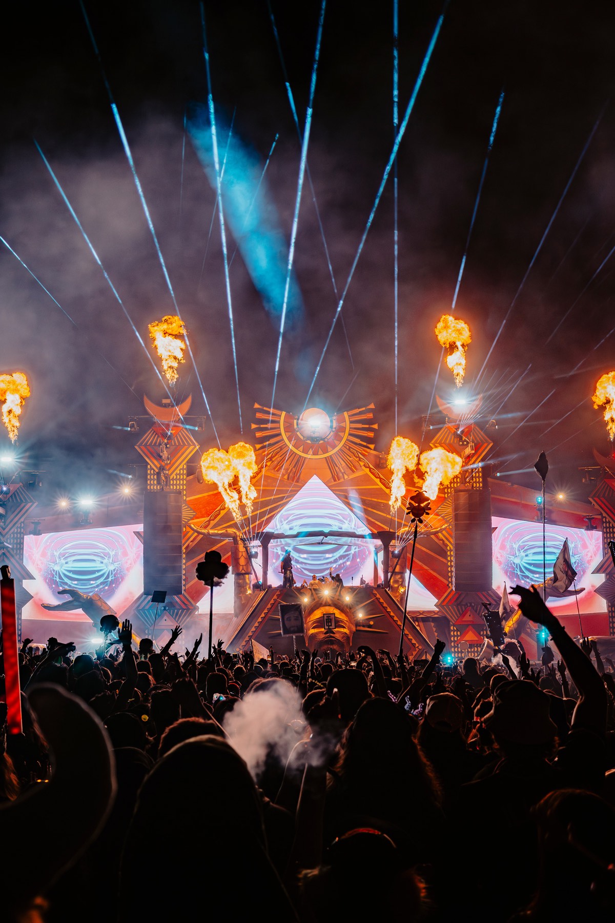 Crowd under green lasers at a live set